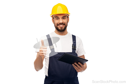 Image of worker or builder with tablet pc showing thumbs up