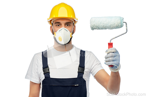 Image of worker or builder in respirator with paint roller