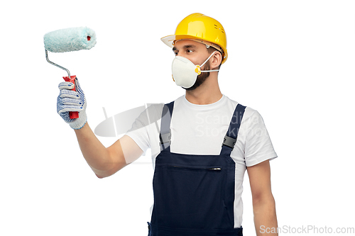 Image of worker or builder in respirator with paint roller