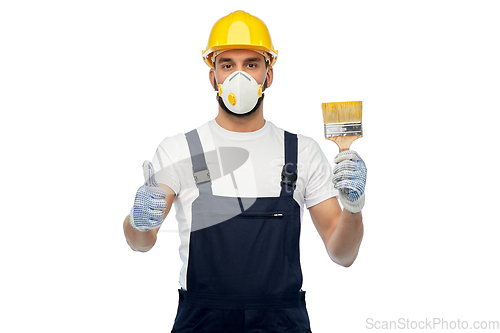 Image of builder in respirator with brush showing thumbs up