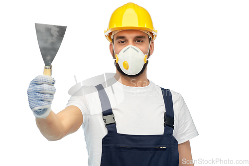 Image of worker or builder in respirator with spatula