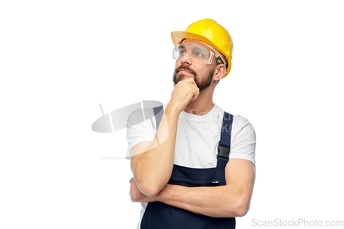 Image of thinking male worker or builder with crossed arms