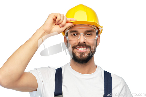 Image of happy male worker or builder in helmet and overall