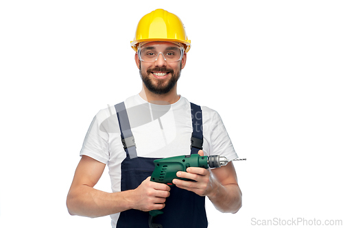 Image of happy male worker or builder in helmet with drill
