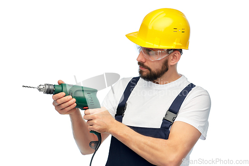 Image of male worker or builder in helmet with drill