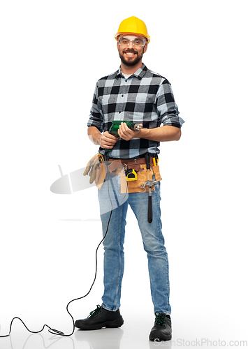 Image of happy male worker or builder in helmet with drill