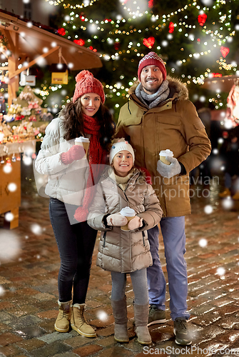 Image of family with takeaway drinks at christmas market