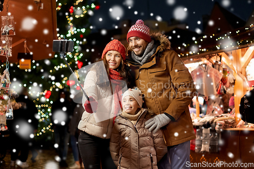 Image of happy family taking selfie at christmas market