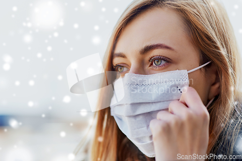 Image of close up of woman wearing protective medical mask