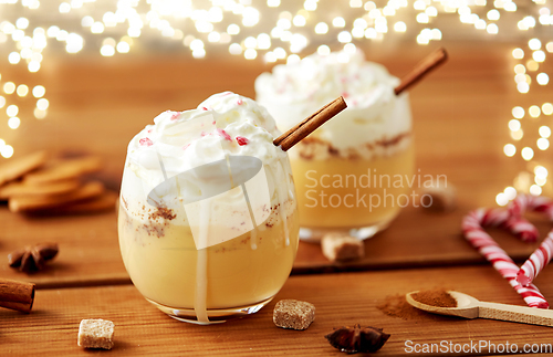 Image of glasses of eggnog with whipped cream and cinnamon