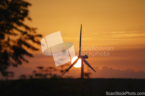 Image of Windmill in a sunset in a rural summer landscape