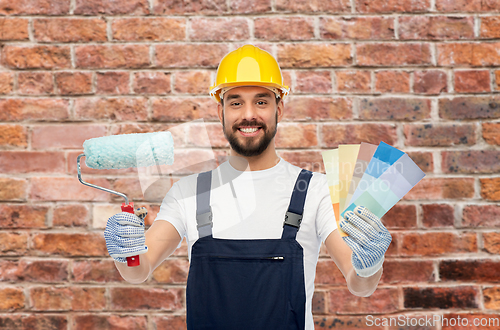 Image of male builder with paint roller and color palettes