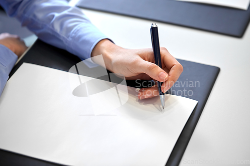 Image of close up of businesswoman with paper at office