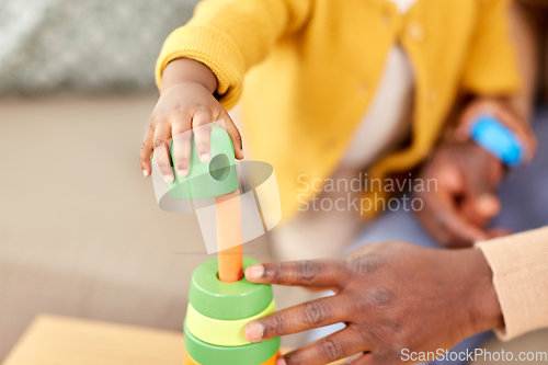 Image of close up of baby playing toy blocks at home