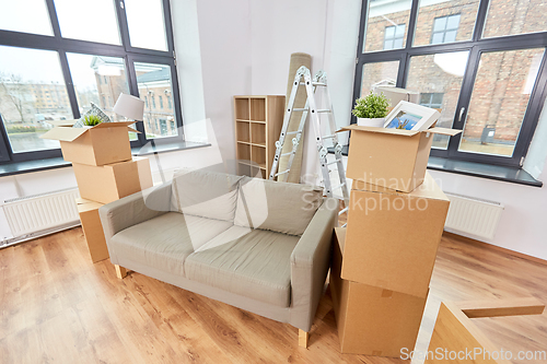 Image of sofa and corrugated boxes with stuff at new home