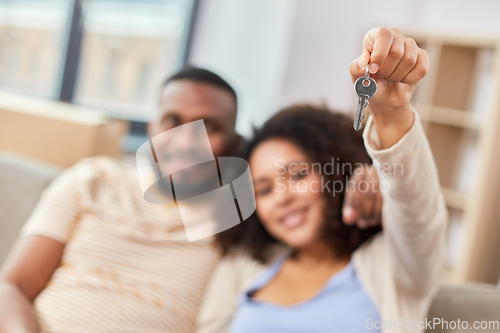 Image of happy couple with house key moving to new home