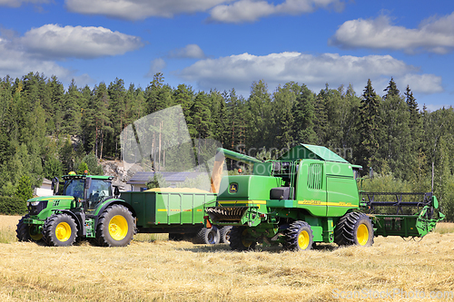 Image of John Deere Combine Unloading Grain on Trailer