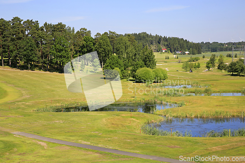 Image of View to a Golf Course with Ponds and Forest 