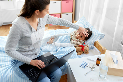 Image of ill daughter and mother with laptop at home