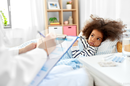 Image of doctor with clipboard and sick girl in bed at home