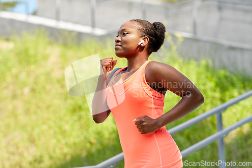 Image of african american woman running outdoors