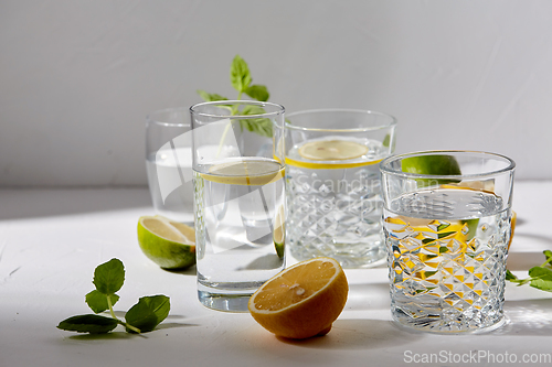 Image of glasses with lemon water and peppermint on table