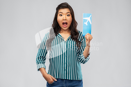 Image of surprised asian woman with air ticket