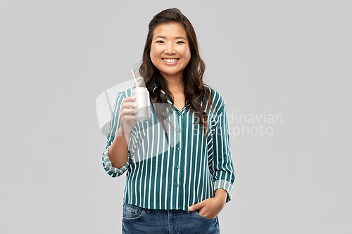 Image of happy smiling asian woman with can drink