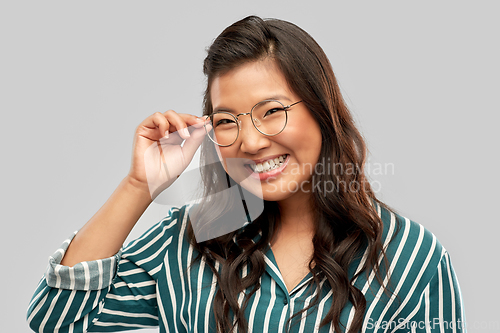 Image of portrait of happy asian woman in glasses