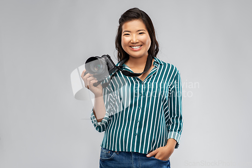 Image of asian female photographer with digital camera