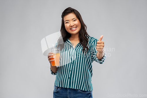 Image of asian woman with juice in plastic cup with straw