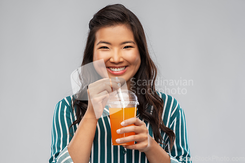 Image of asian woman with juice in plastic cup with straw