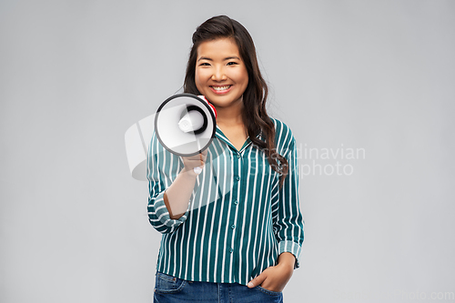 Image of happy smiling asian woman speaking to megaphone