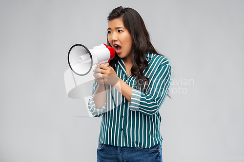 Image of angry young asian woman speaking to megaphone