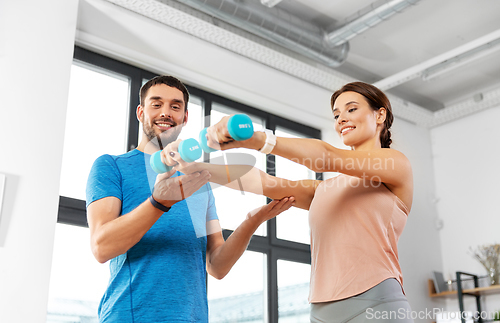 Image of happy couple exercising at home