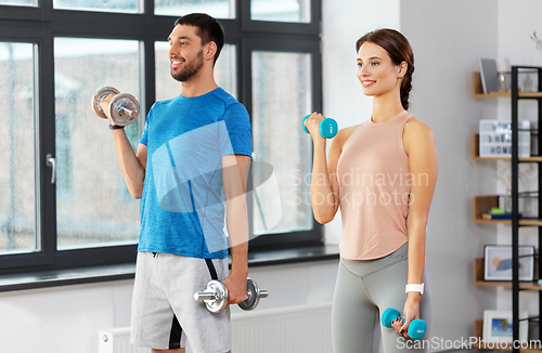 Image of happy couple exercising at home