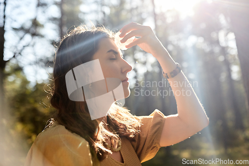 Image of woman or witch performing magic ritual in forest