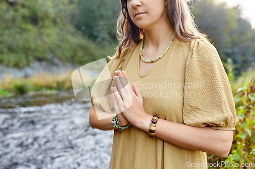 Image of woman or witch performing magic ritual on river