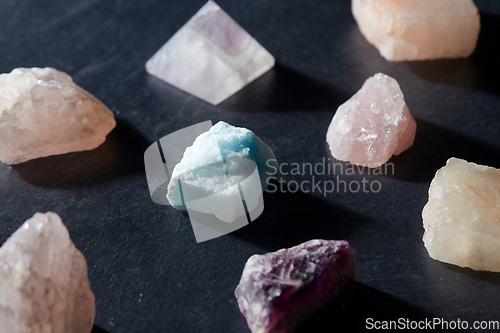 Image of quartz crystals and gem stones on slate background