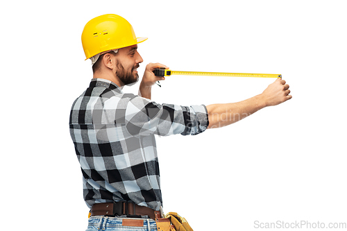 Image of happy male worker or builder in helmet with ruler