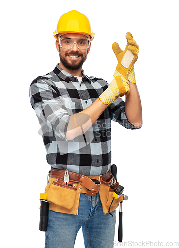 Image of happy male worker or builder in helmet and gloves