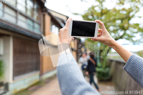 Image of Taking photo by cellphone in old town of Japan