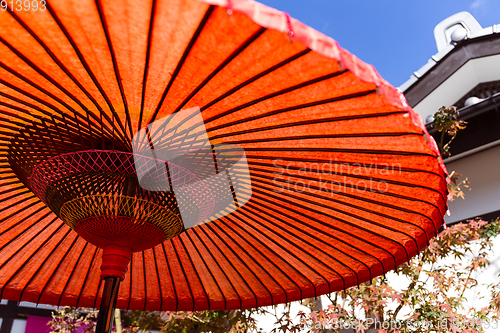 Image of Japanese red umbrella at autumn