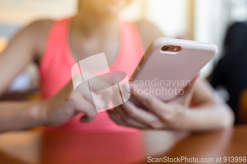 Image of Woman sending sms on cellphone