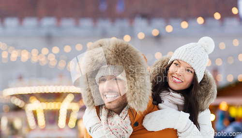 Image of happy couple over christmas market background