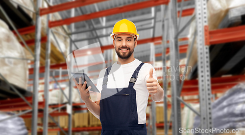 Image of loader with tablet pc shows thumbs up at warehouse