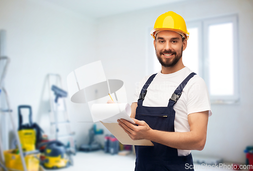 Image of male worker or builder in helmet with clipboard