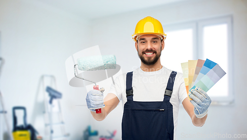 Image of male builder with paint roller and color palettes