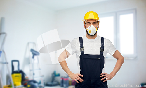 Image of male worker or builder in helmet and respirator