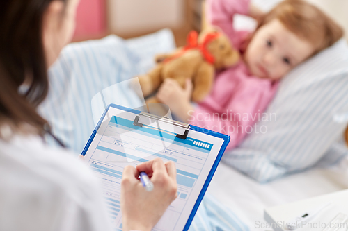 Image of doctor with clipboard and sick girl in bed at home